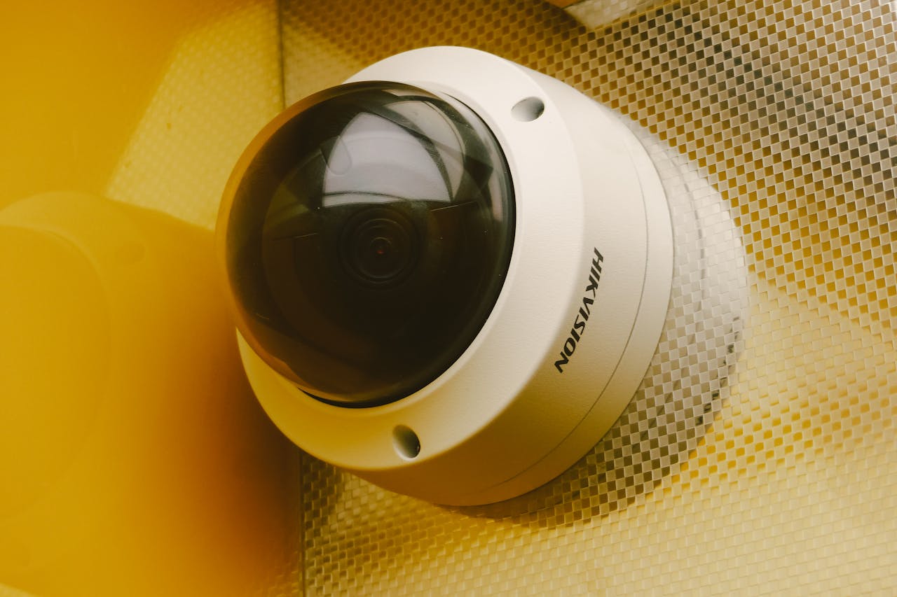 creative-02 Close-up of a modern security camera installed indoors, ideal for surveillance.